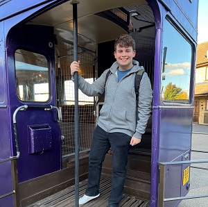 Marcus at the back of a purple double decker bus