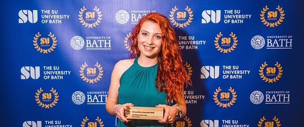 An academic rep collecting their award at the Education Awards