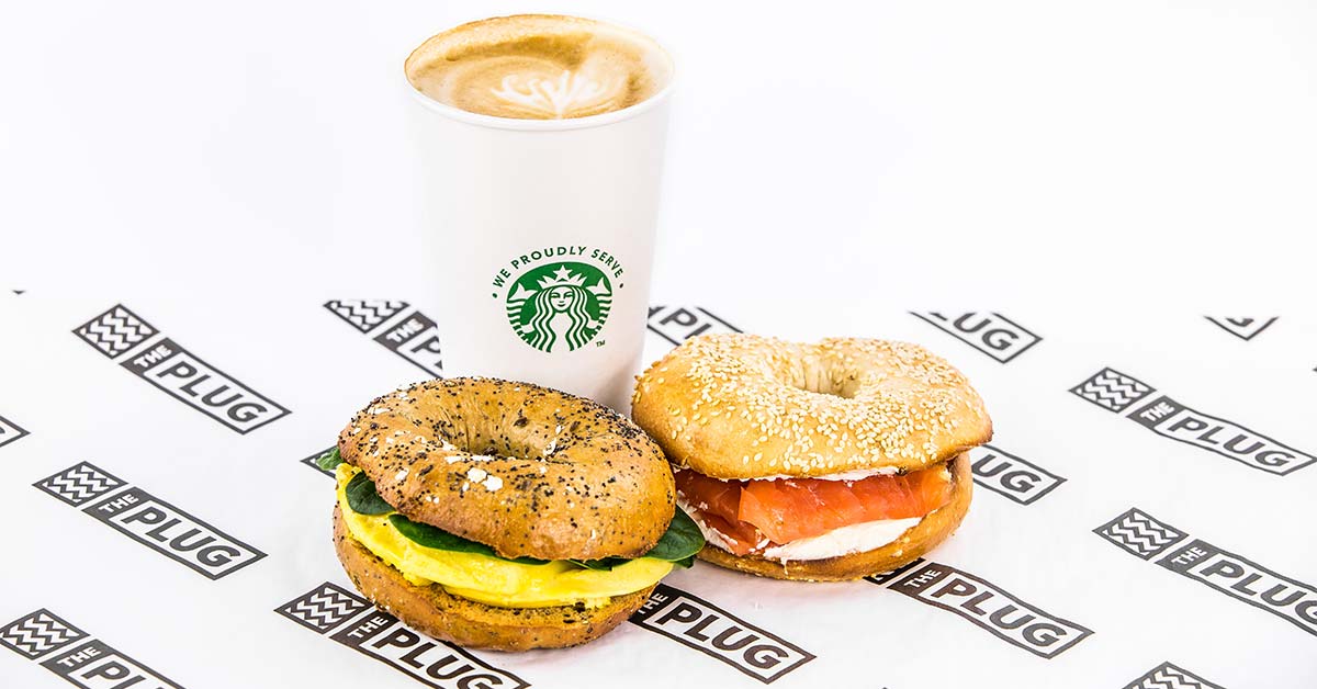 A photograph of two bagels and a coffee
