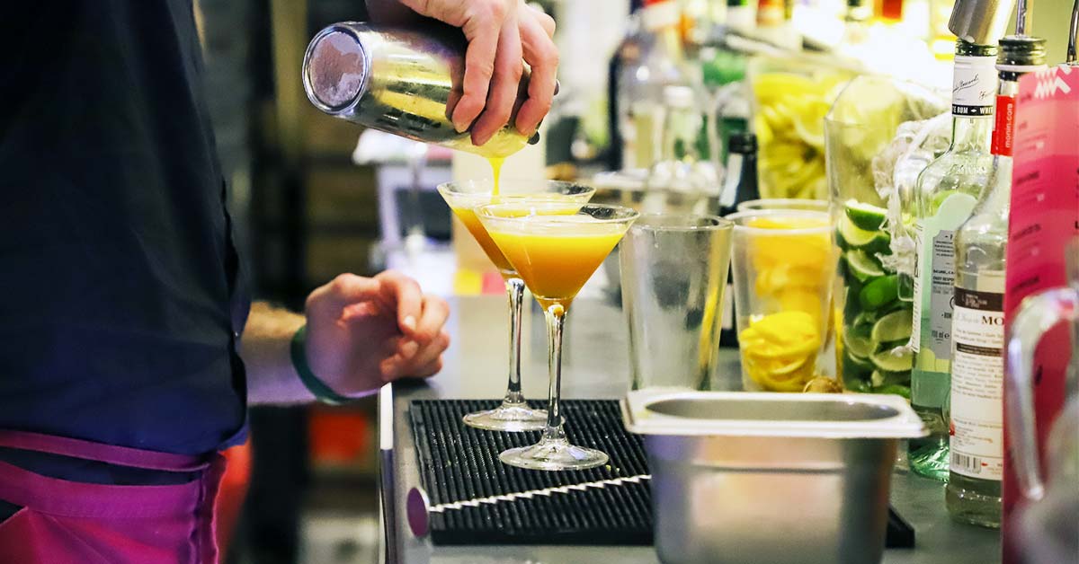 A staff member pouring a cocktail