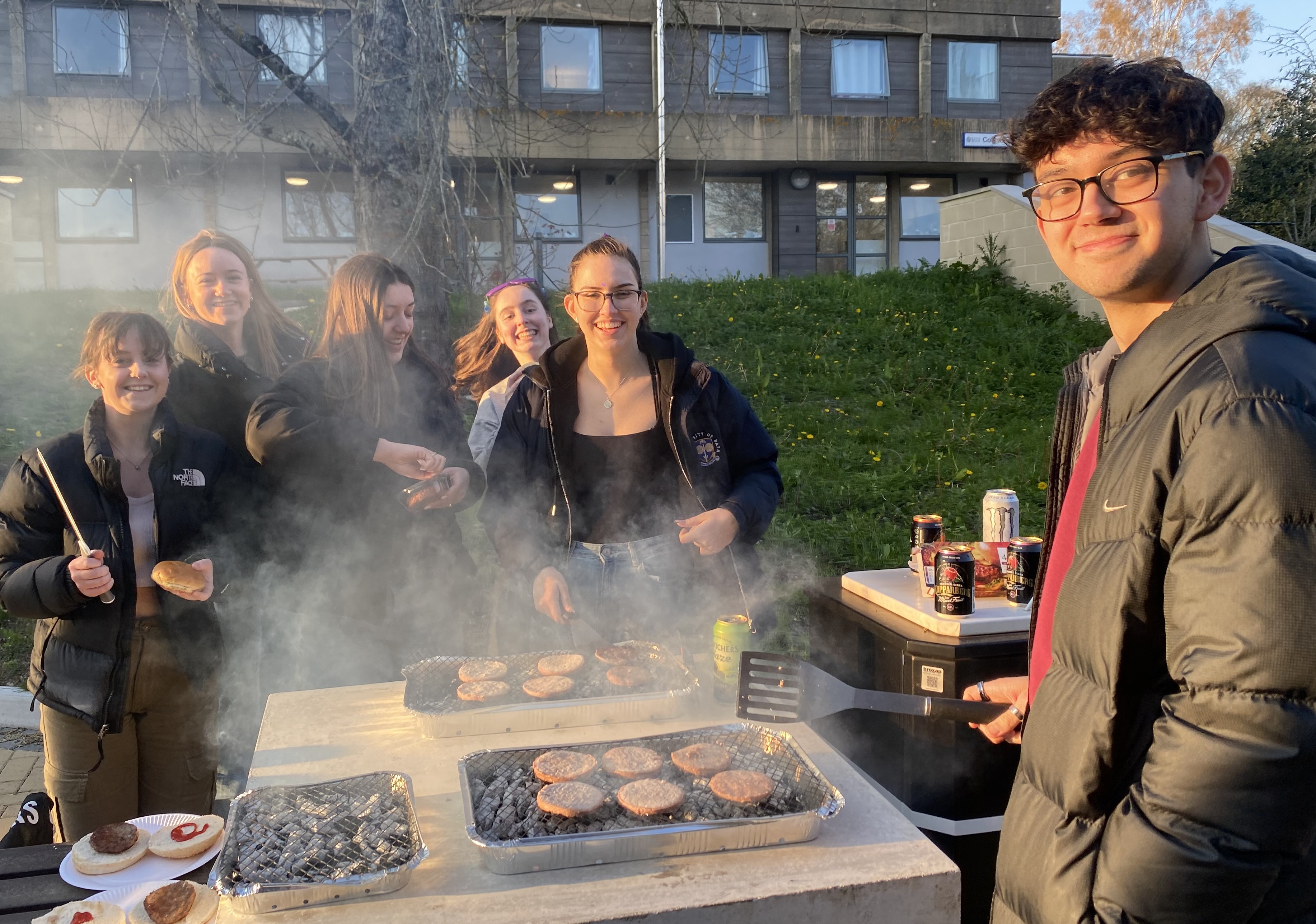 Four students at a BBQ event