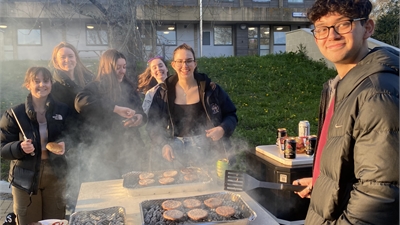 Four students at a BBQ event