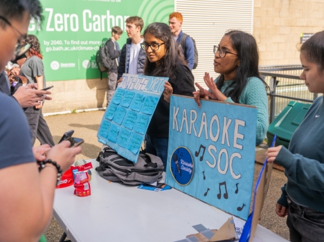Students from Karaoke soc signing up new members at a table