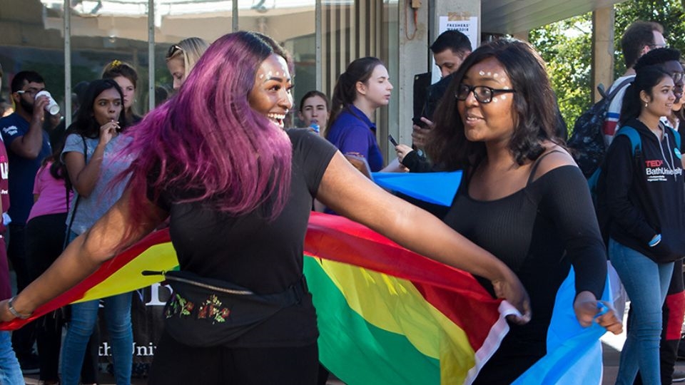 Image of 2 international students with a flag