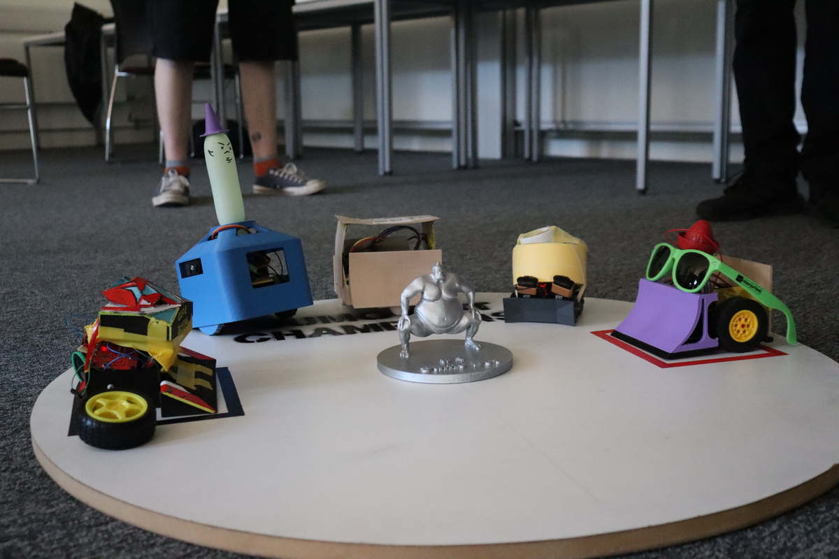 3d printed sumo robots on ring with trophy