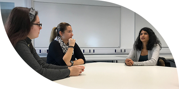 Students talking at a table.