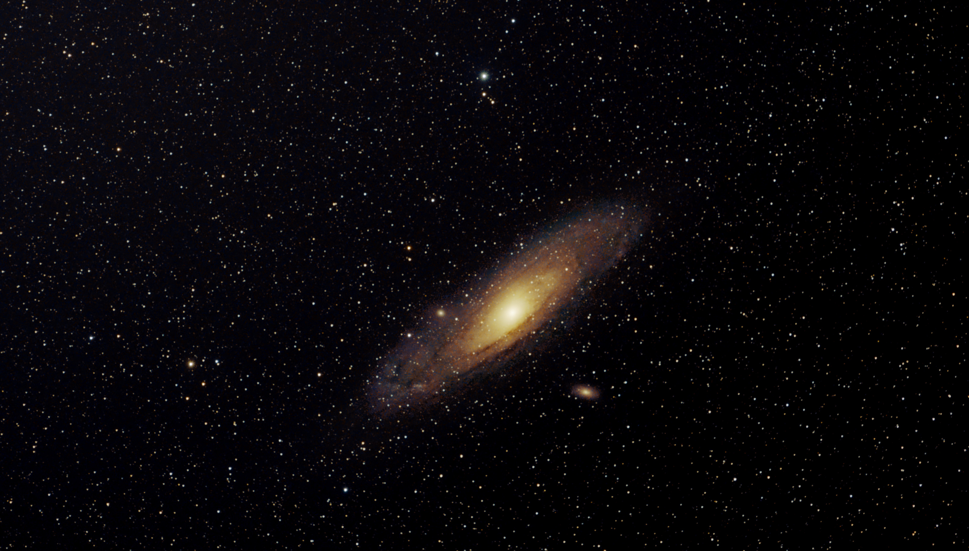 Colour photo of Andromeda galaxy. Dwalf galaxies M32 and M110 are also visible.