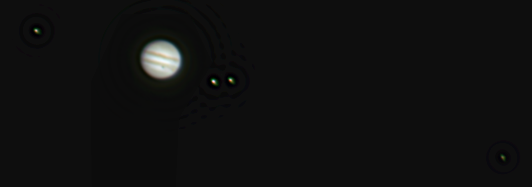Colour photo of Jupiter with all 4 galilean moons. Ganemede is casting a shadow on Jupiter.