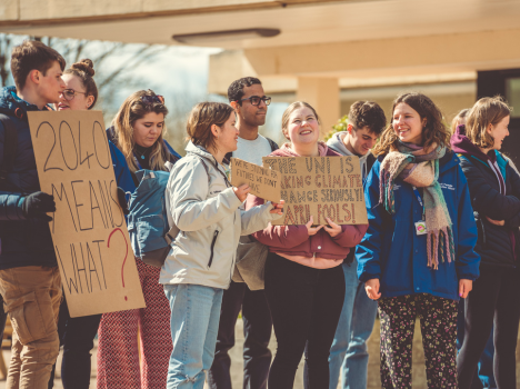 Students protesting with cardboard banners on Bath Uni Campus