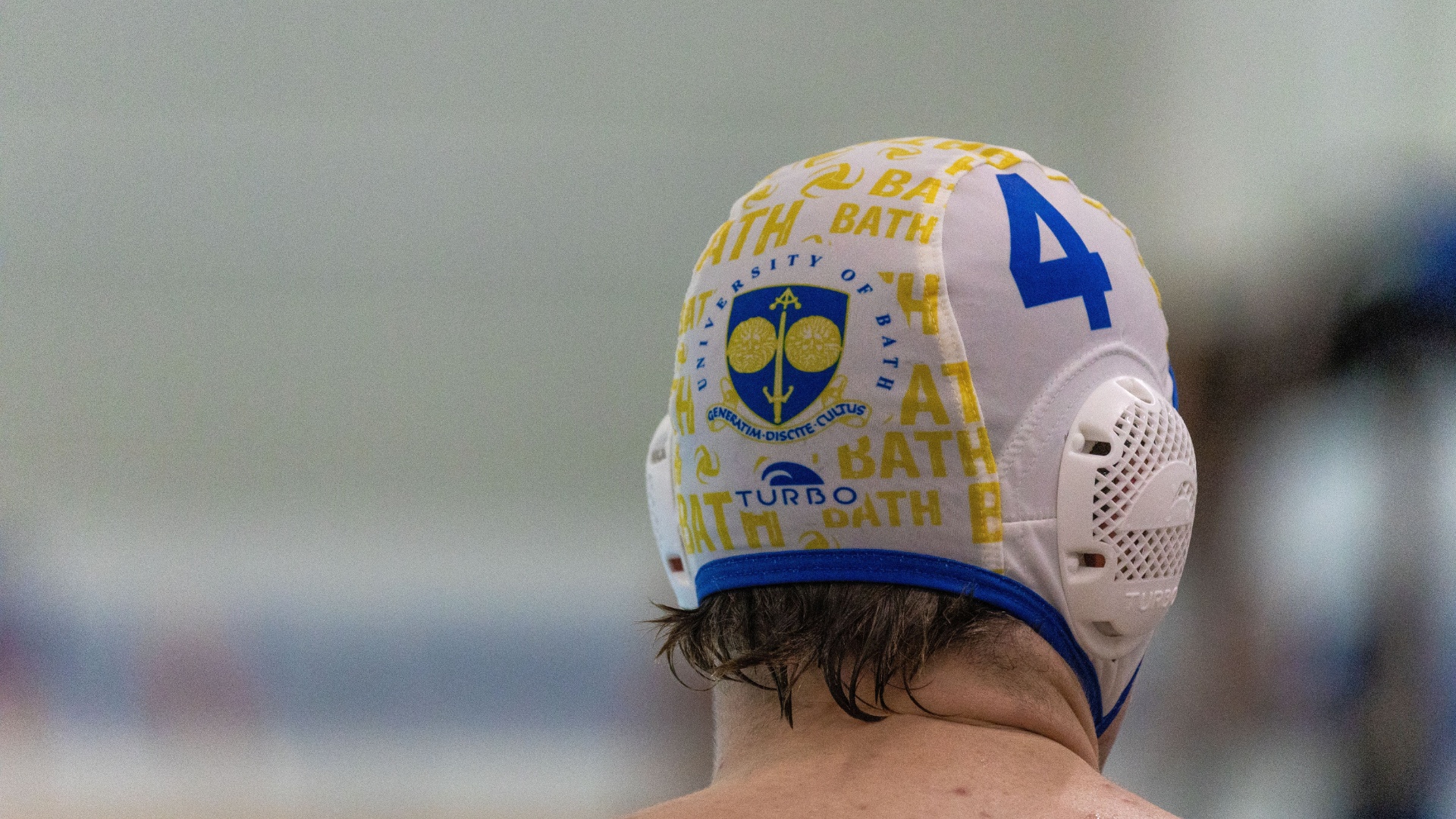 Student wearing swimmers cap