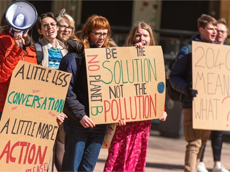 An officer sitting at a table in front of a room of students