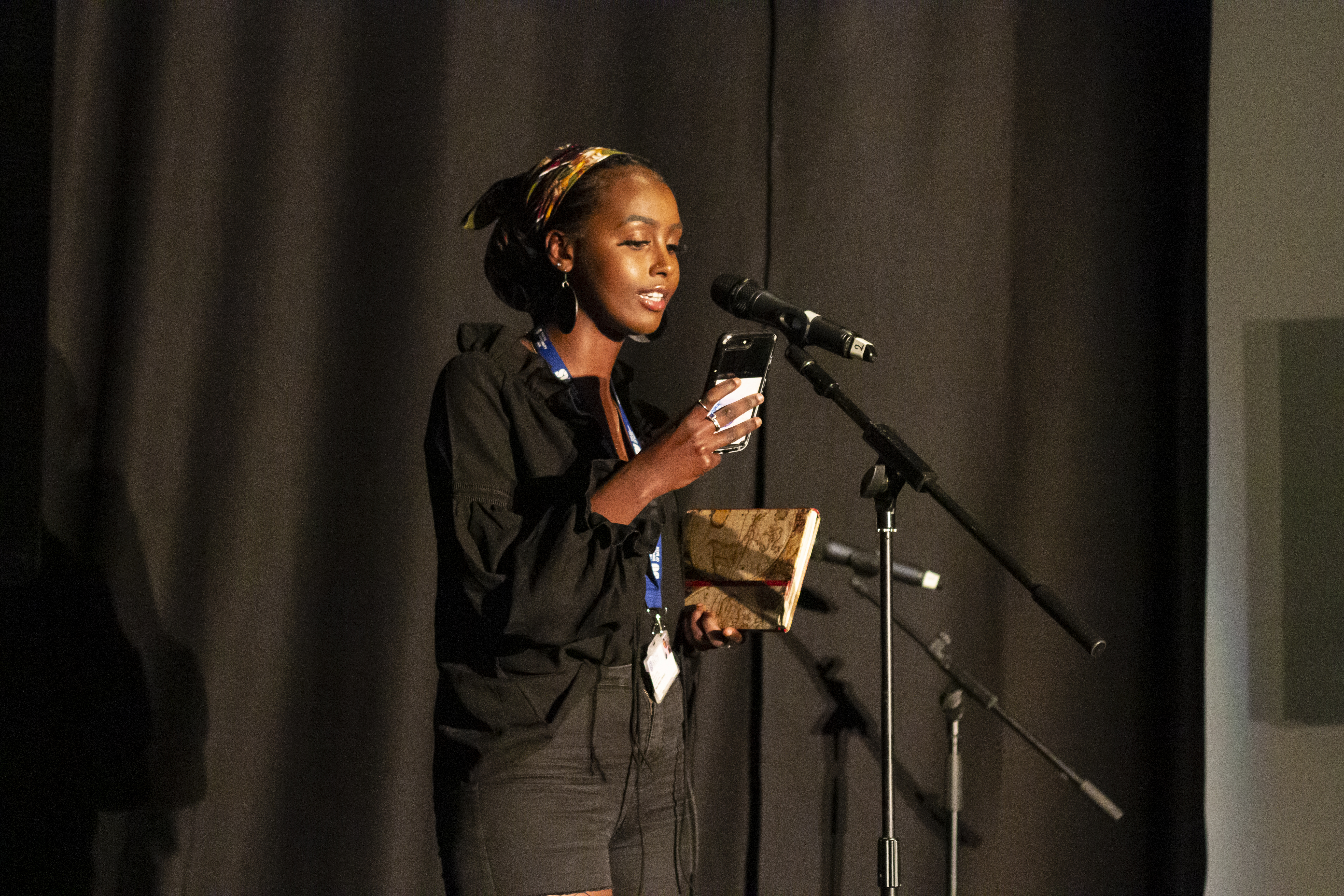 A woman speaking at a microphone